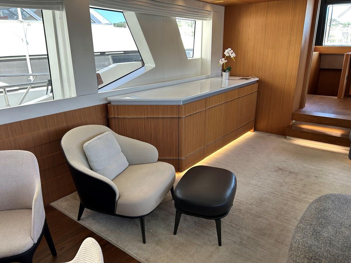 a room with a chair and a counter and chairs aboard YES Yacht for Sale