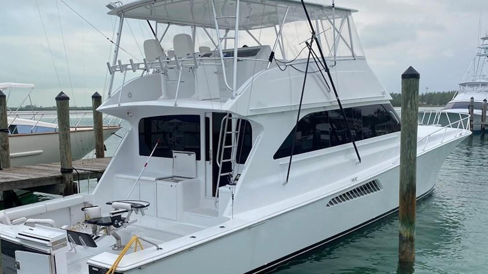 a white boat docked aboard ALL IN Yacht for Sale