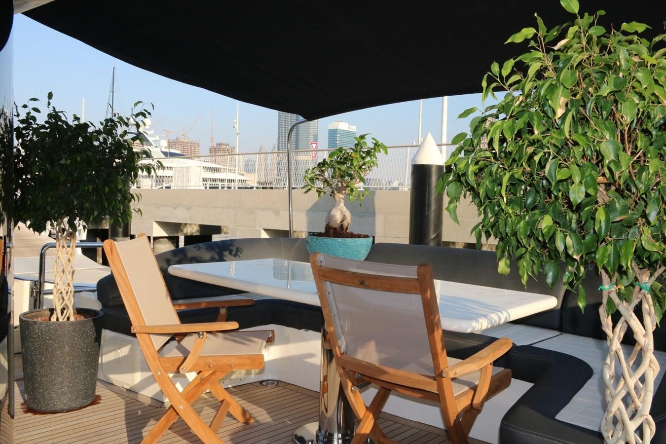 a table and chairs on a patio aboard SIMONA Yacht for Sale