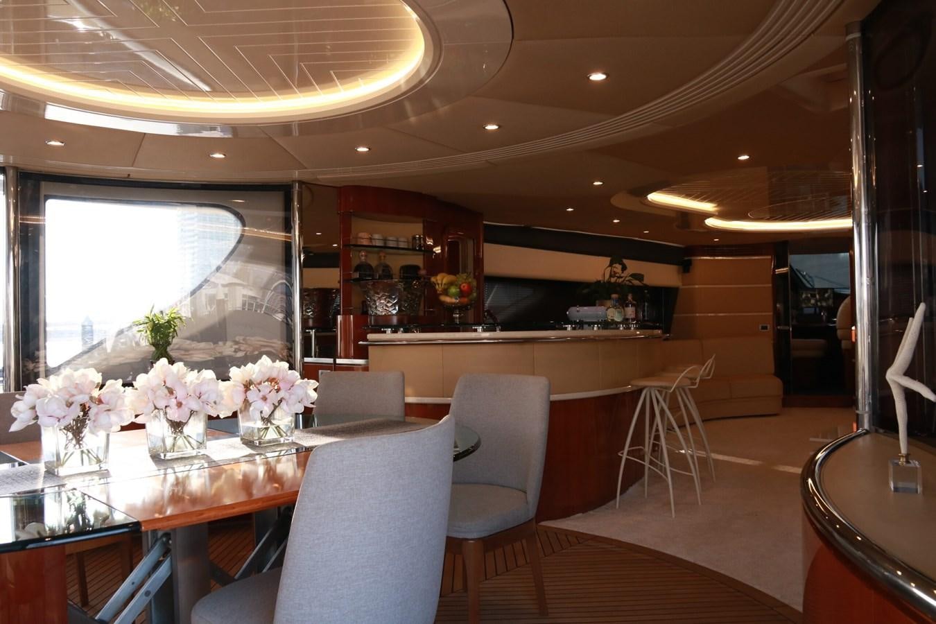 a room with a table chairs and flowers in it aboard SIMONA Yacht for Sale