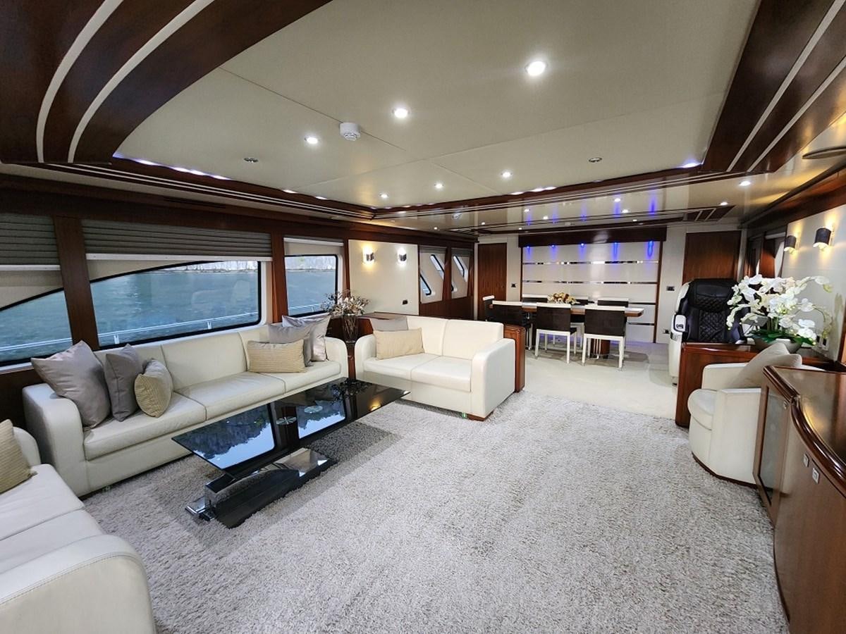 a living room with a large window aboard BLUE SAPPHIRE Yacht for Sale