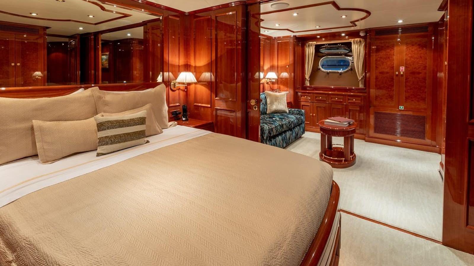 a room with a bed and a chair aboard FELICITA Yacht for Sale