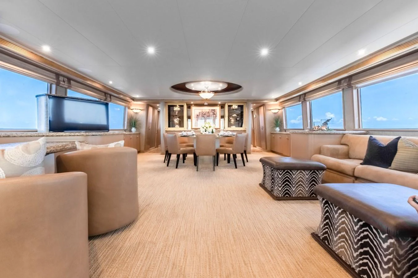 a large living room with a large screen aboard CHECKERED PAST Yacht for Sale