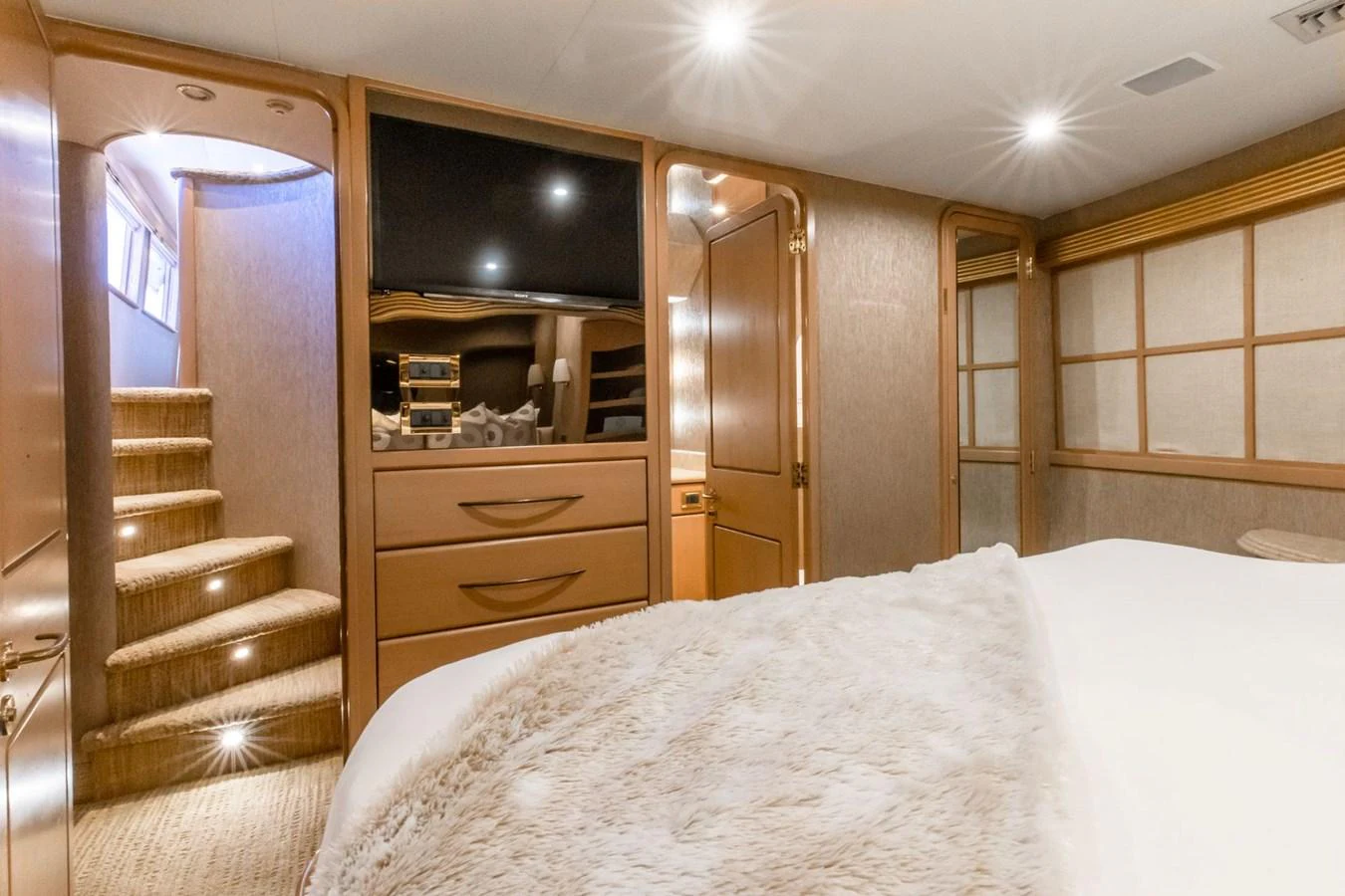 a bedroom with a bed and a closet aboard CHECKERED PAST Yacht for Sale