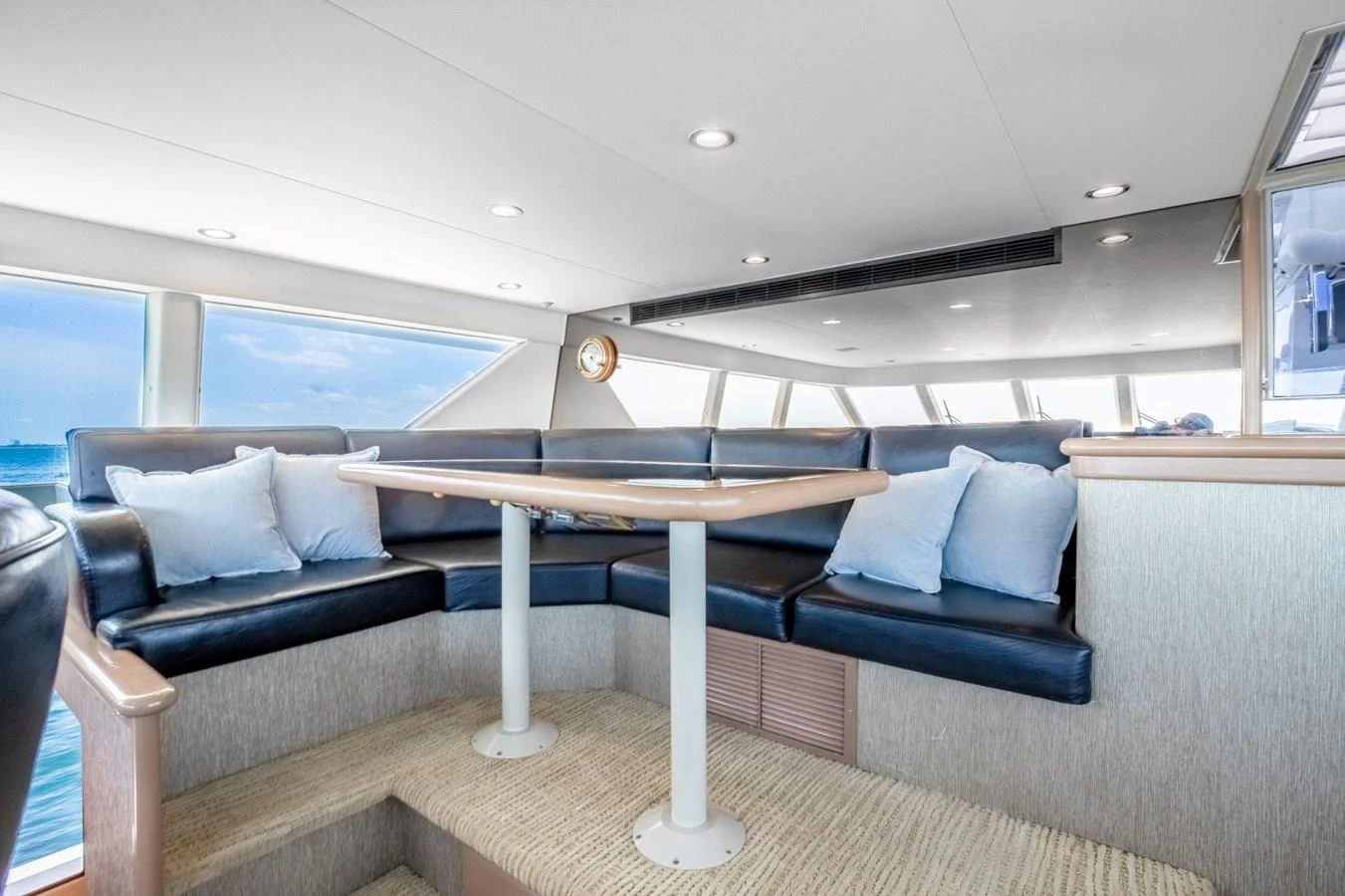 a room with a couch and a table aboard CHECKERED PAST Yacht for Sale