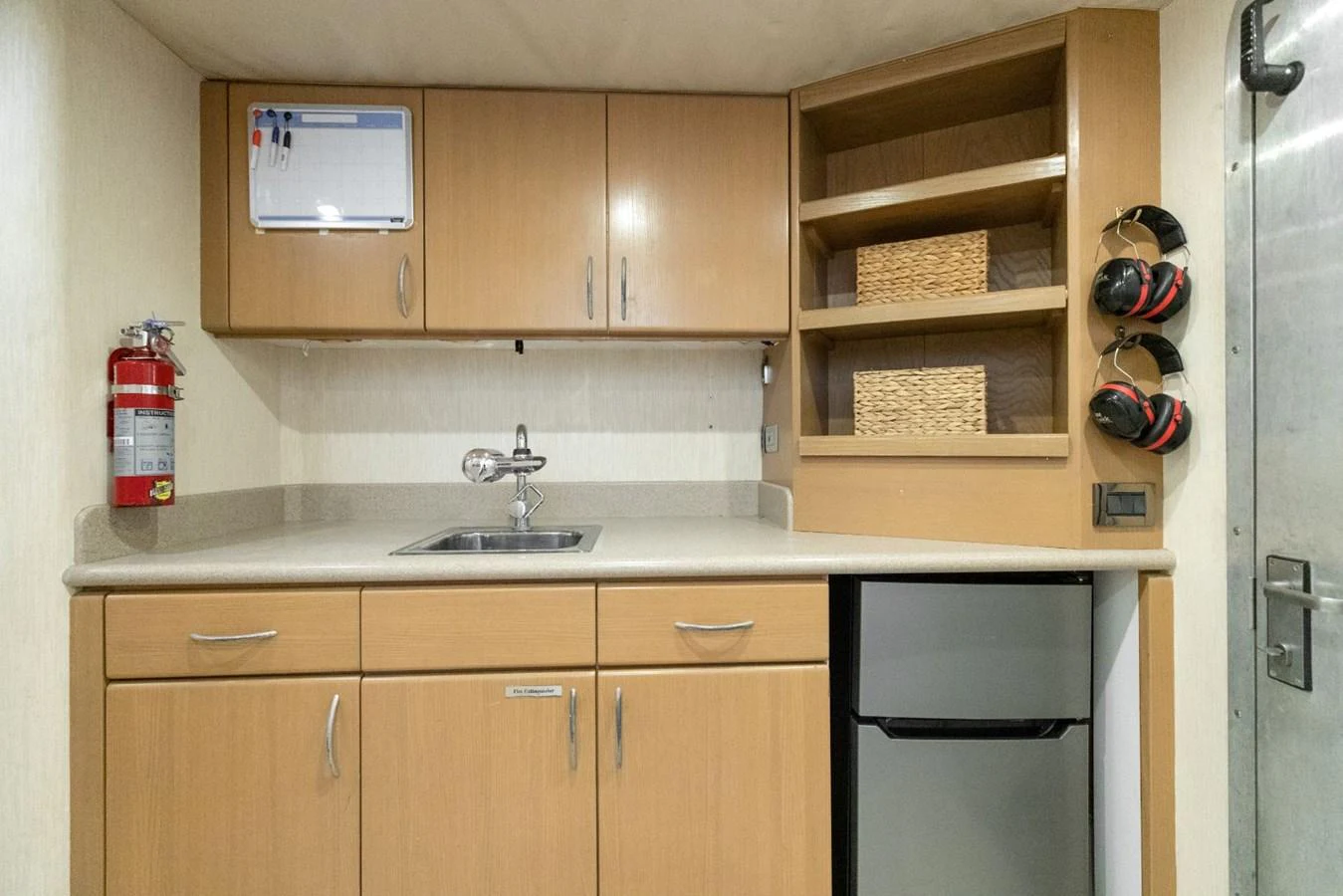 a kitchen with wooden cabinets aboard CHECKERED PAST Yacht for Sale