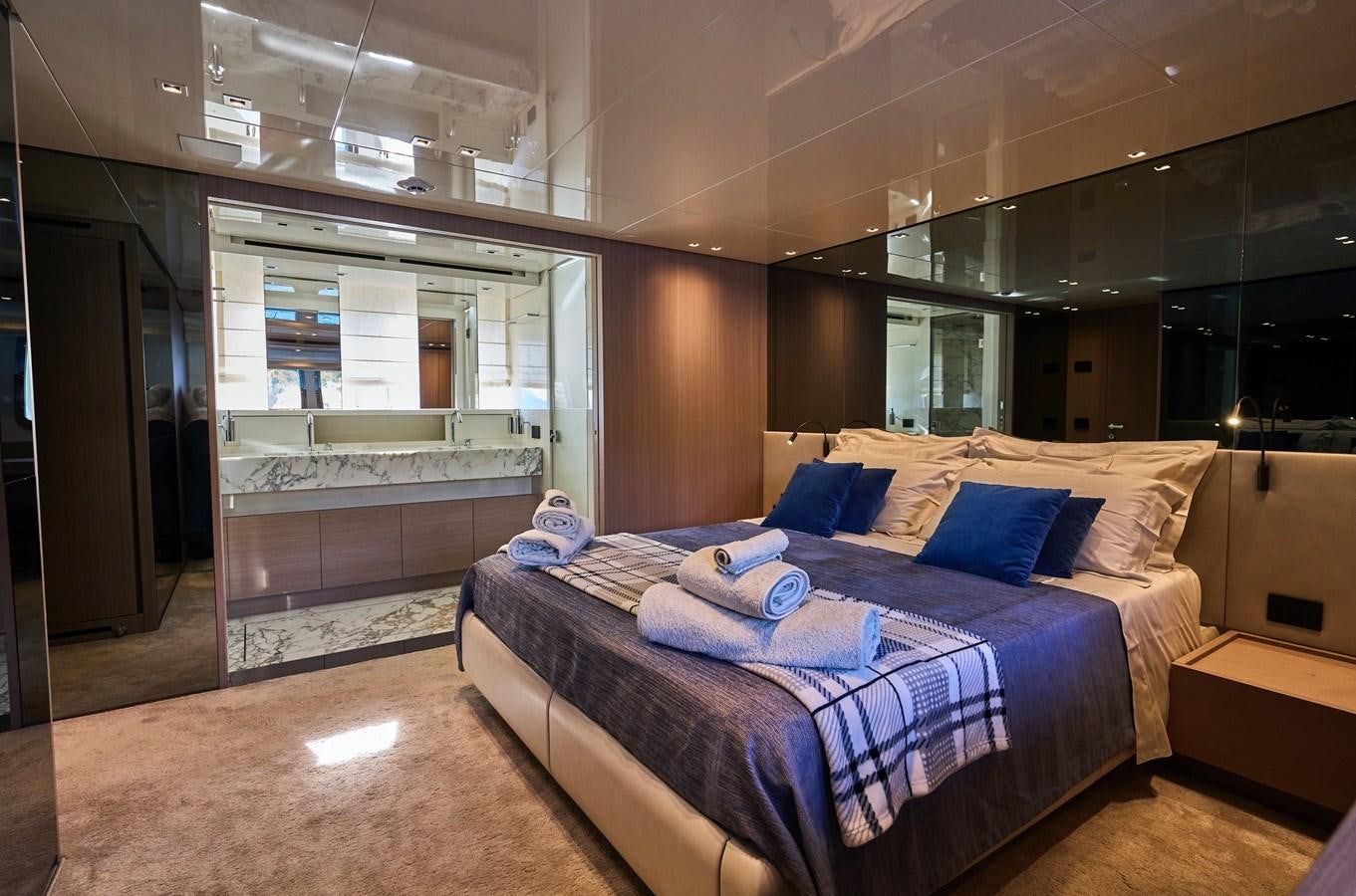 a room with a bed and a desk aboard ESTIA Yacht for Sale