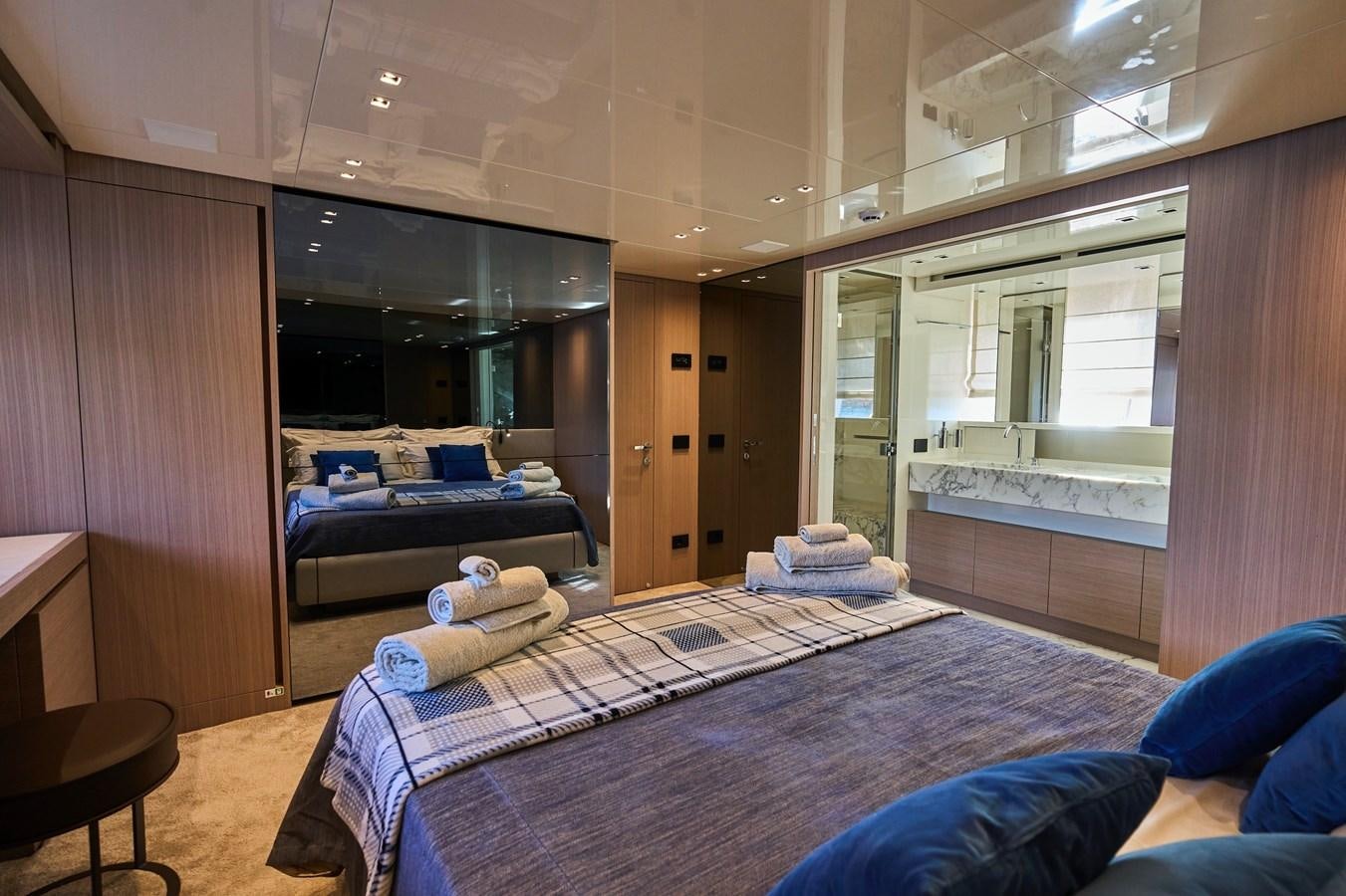 a room with a bed and a couch aboard ESTIA Yacht for Sale