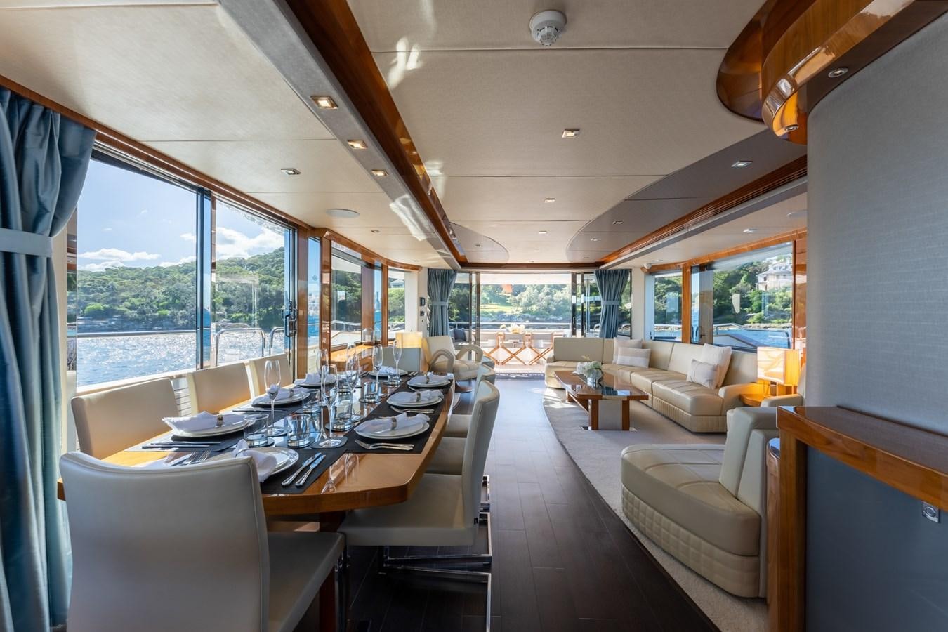 a large dining room with a large window aboard ULTRAVIOLET Yacht for Sale