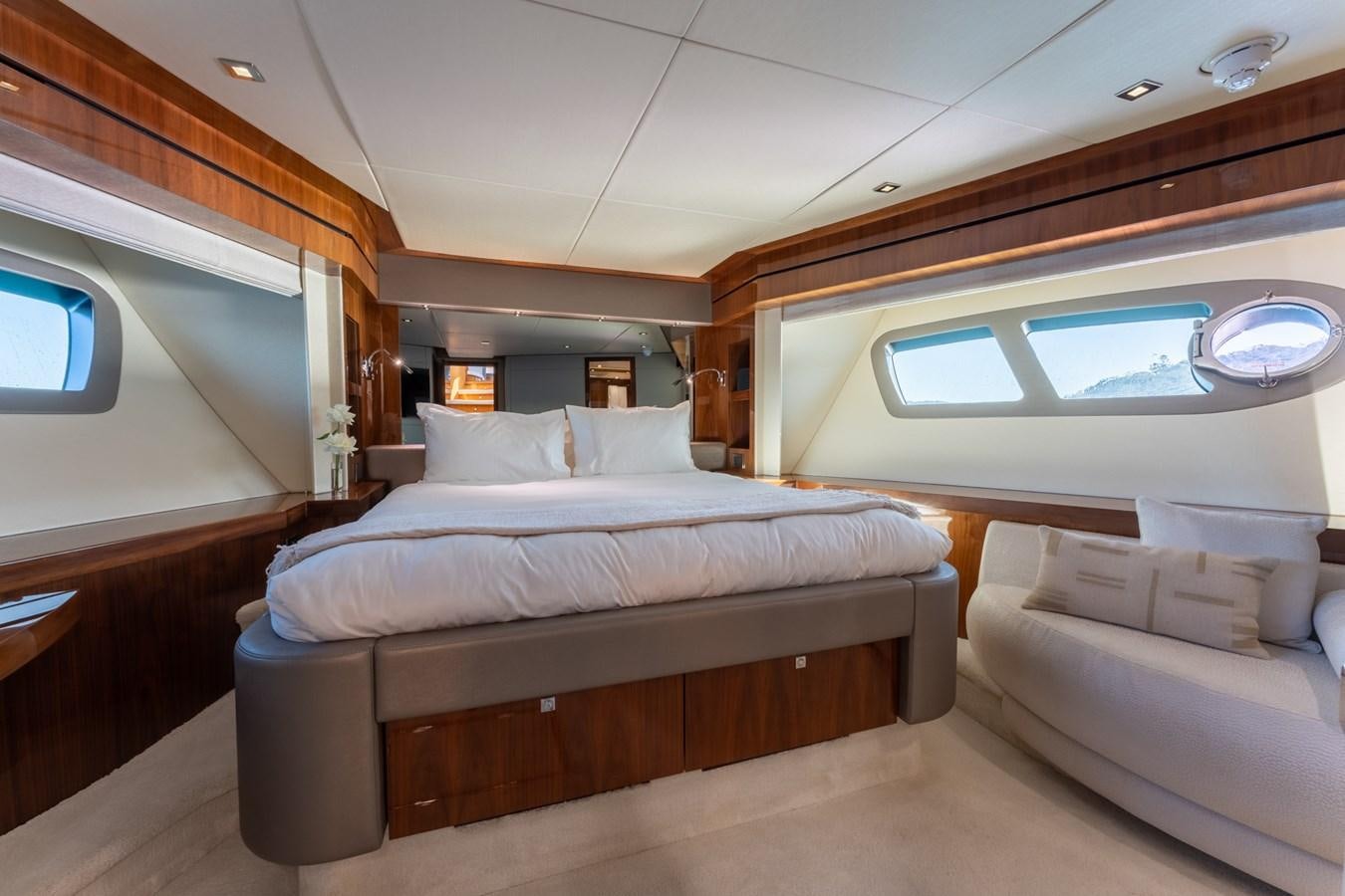 a room with a bed and a couch aboard ULTRAVIOLET Yacht for Sale