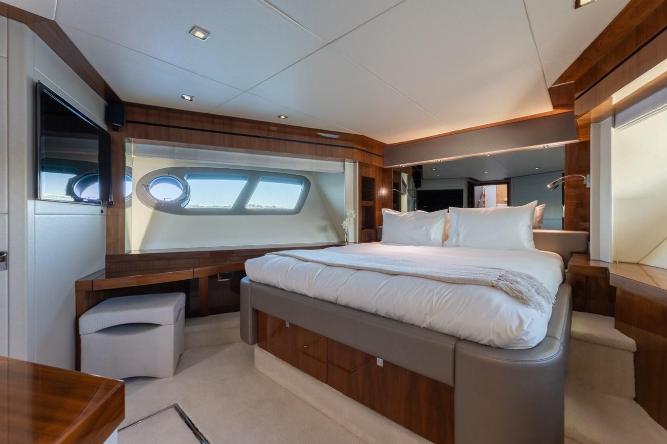 a room with a bed and a desk aboard ULTRAVIOLET Yacht for Sale
