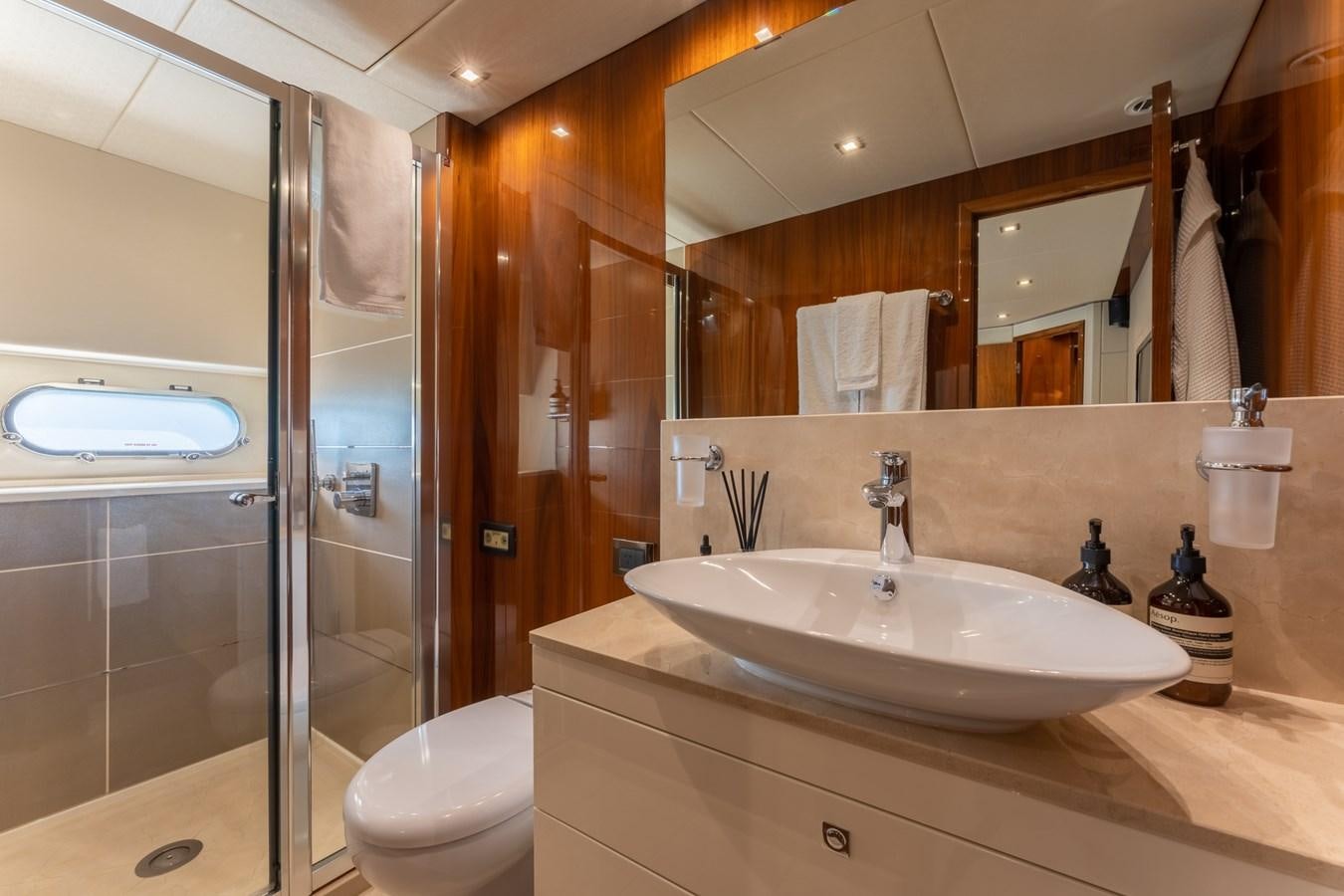 a bathroom with a large mirror aboard ULTRAVIOLET Yacht for Sale
