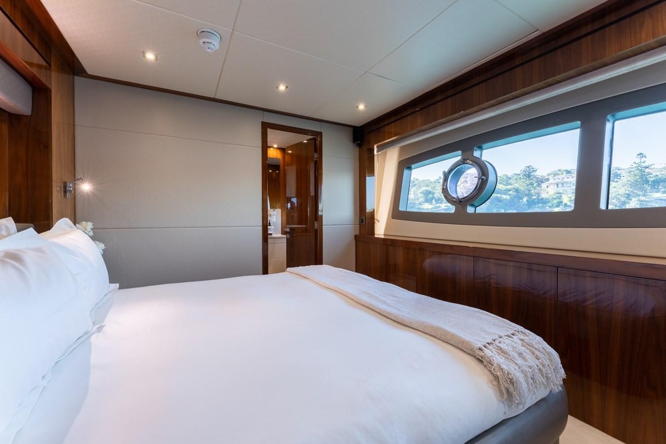 a bed with a white sheet aboard ULTRAVIOLET Yacht for Sale