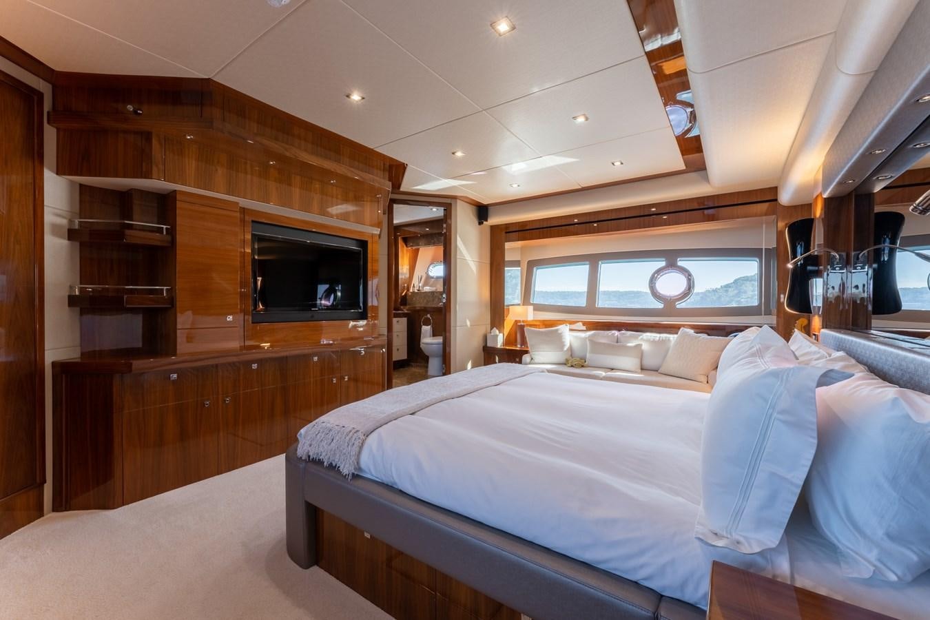 a room with a bed and a television aboard ULTRAVIOLET Yacht for Sale