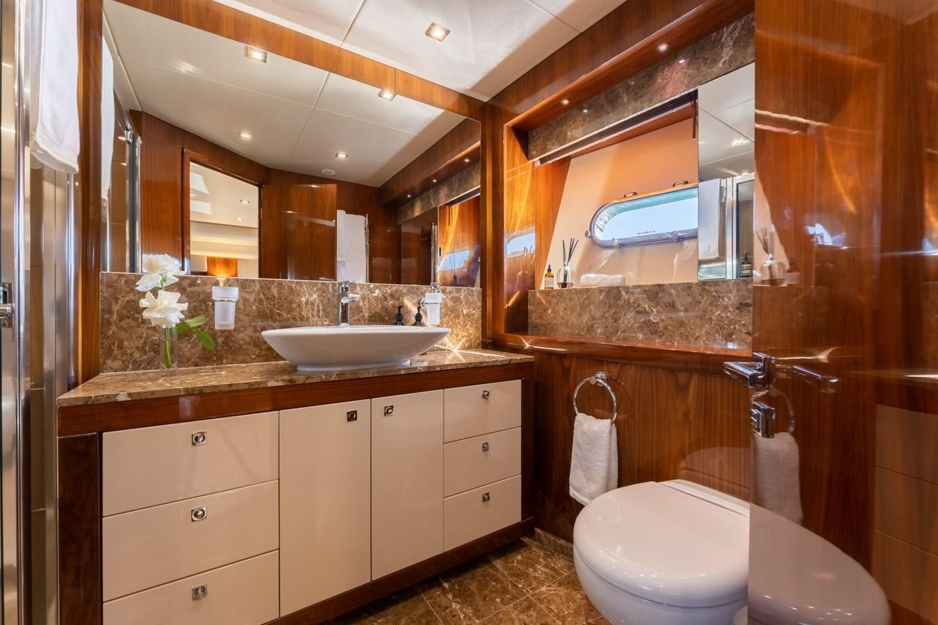 a bathroom with a large mirror aboard ULTRAVIOLET Yacht for Sale