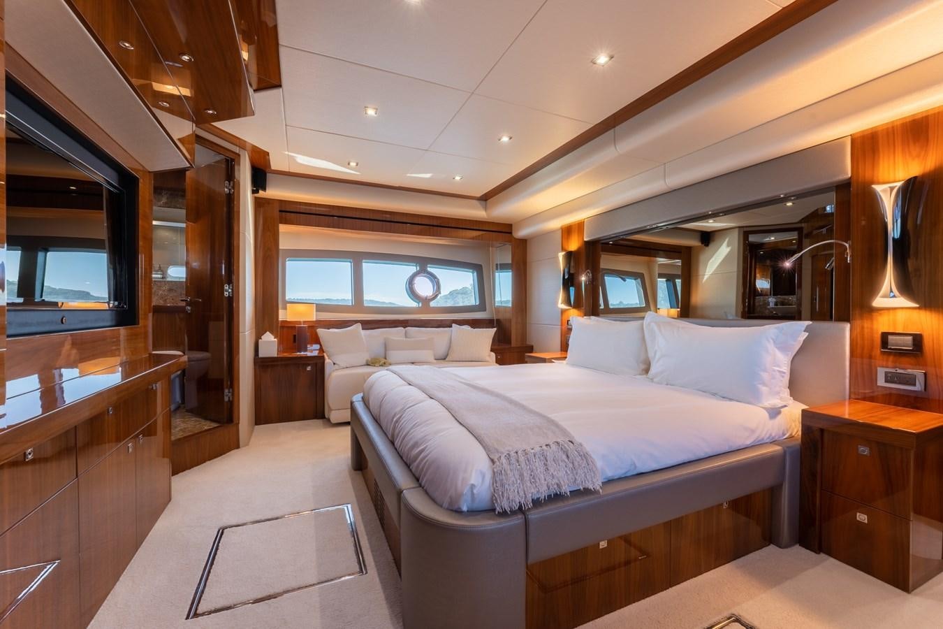 a bedroom with a bed and a desk aboard ULTRAVIOLET Yacht for Sale