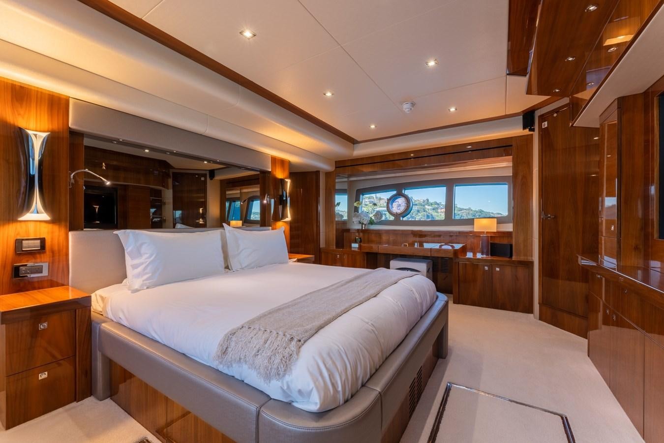 a room with a bed and a large mirror aboard ULTRAVIOLET Yacht for Sale