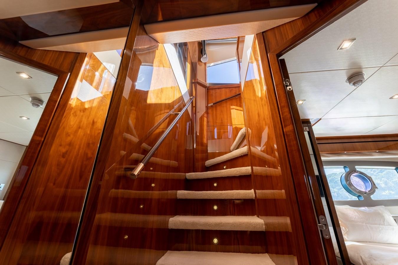 a staircase with glass walls aboard ULTRAVIOLET Yacht for Sale