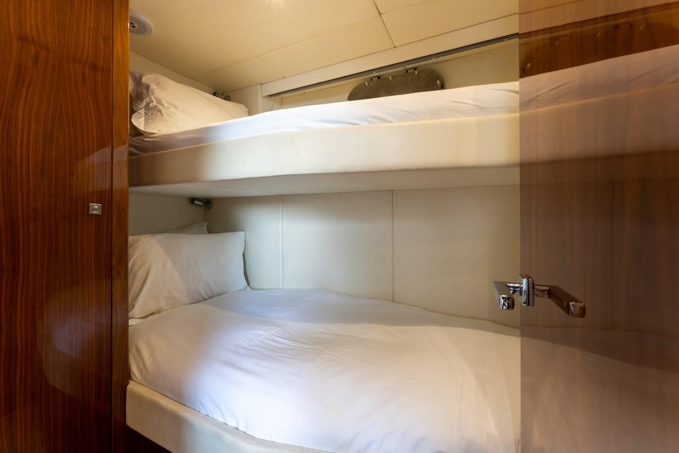 a bed with white sheets aboard ULTRAVIOLET Yacht for Sale