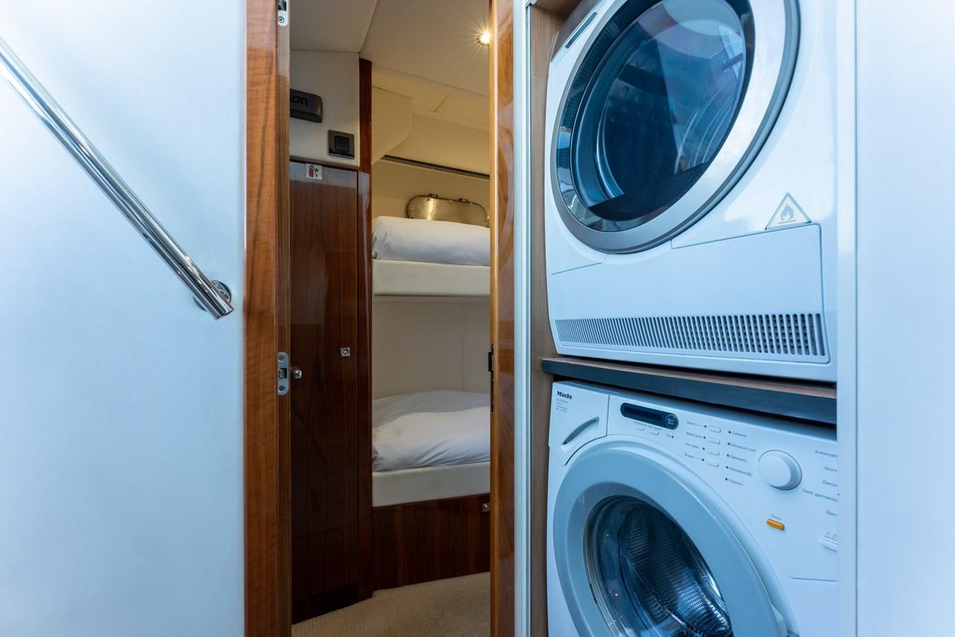 a washer and dryer in a closet aboard ULTRAVIOLET Yacht for Sale
