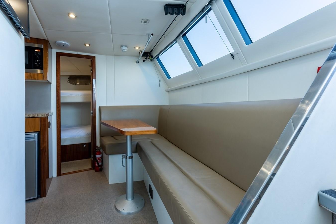a room with a table and a chair aboard ULTRAVIOLET Yacht for Sale