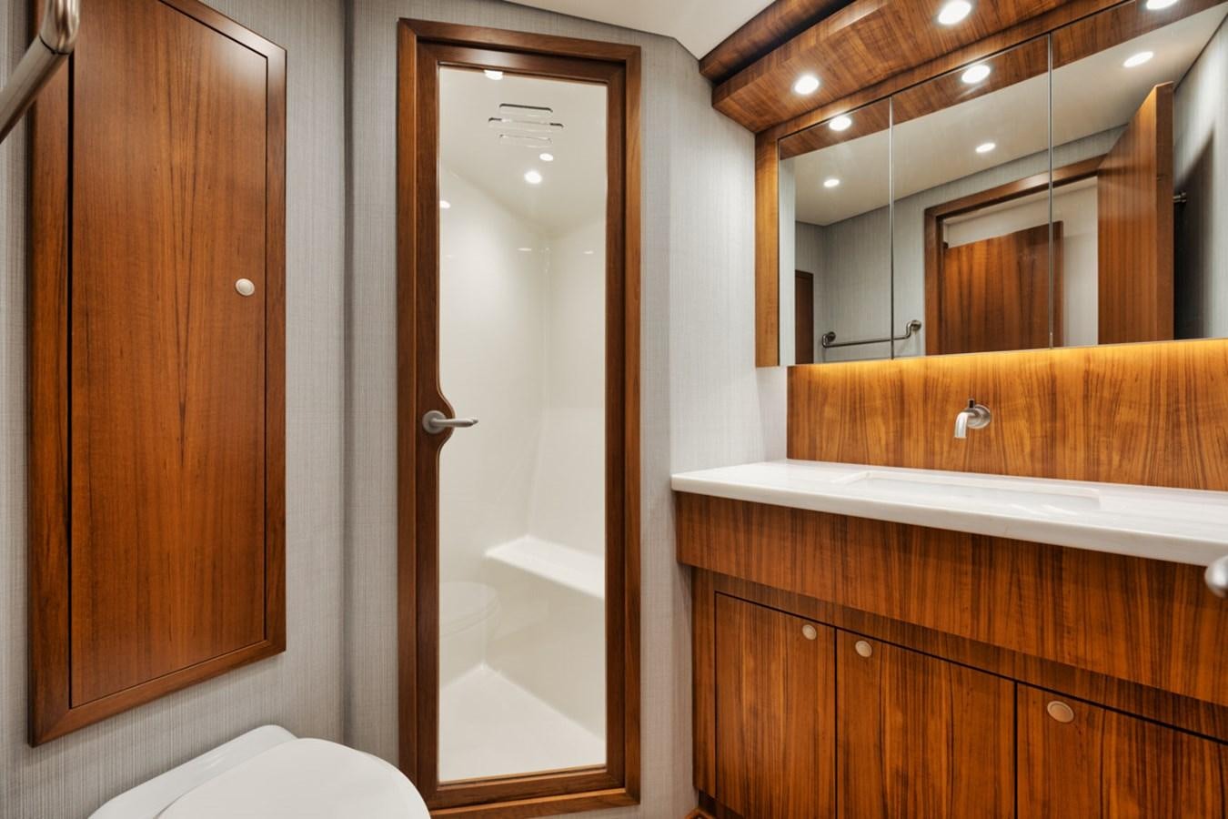 a bathroom with a large mirror aboard FULL TIME Yacht for Sale