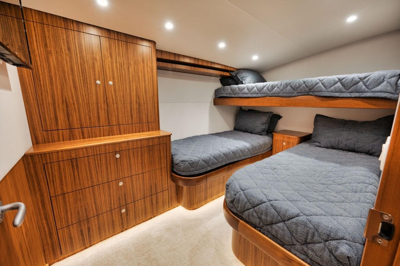 a bedroom with a bed and a dresser aboard FULL TIME Yacht for Sale