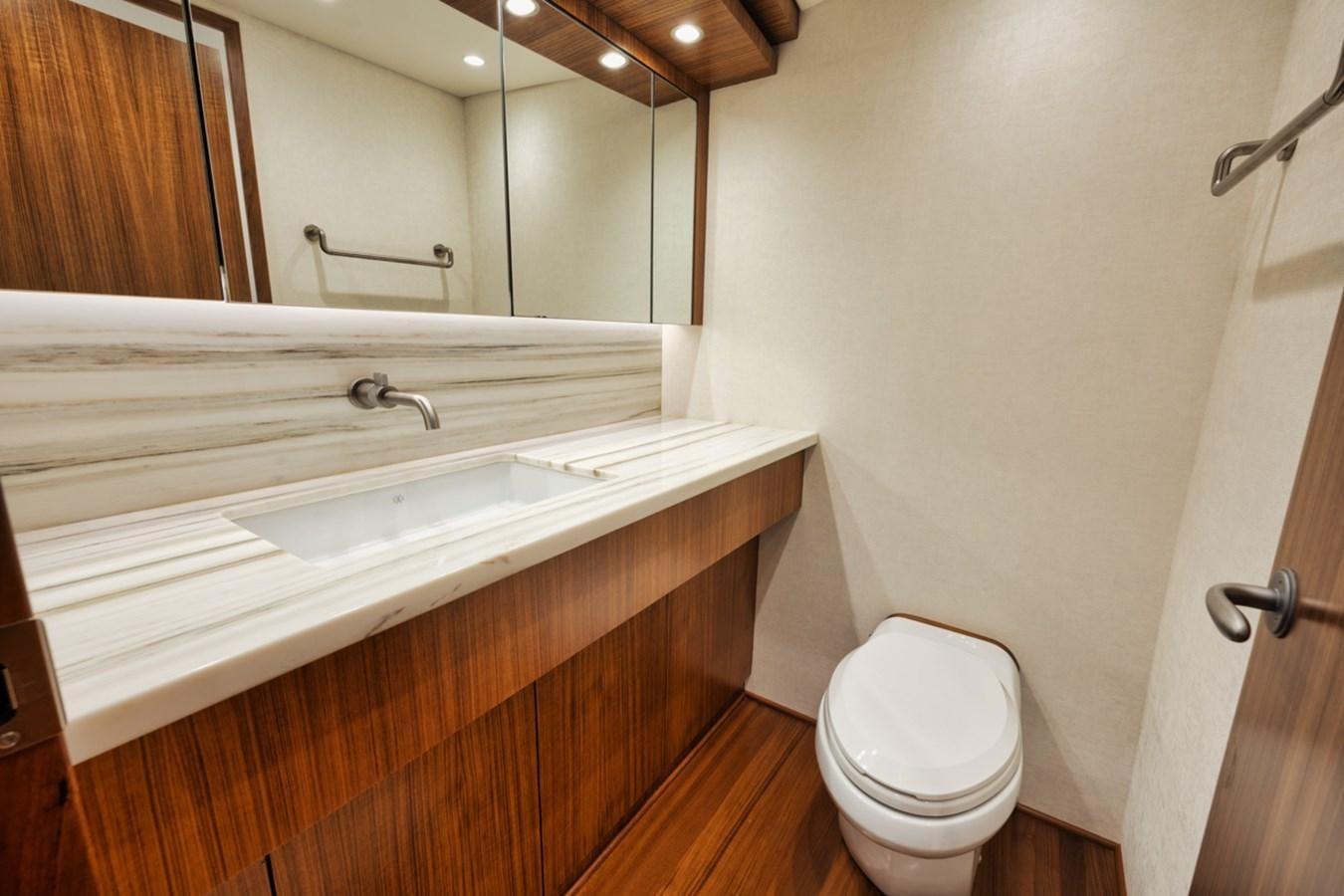 a bathroom with a toilet and a sink aboard FULL TIME Yacht for Sale