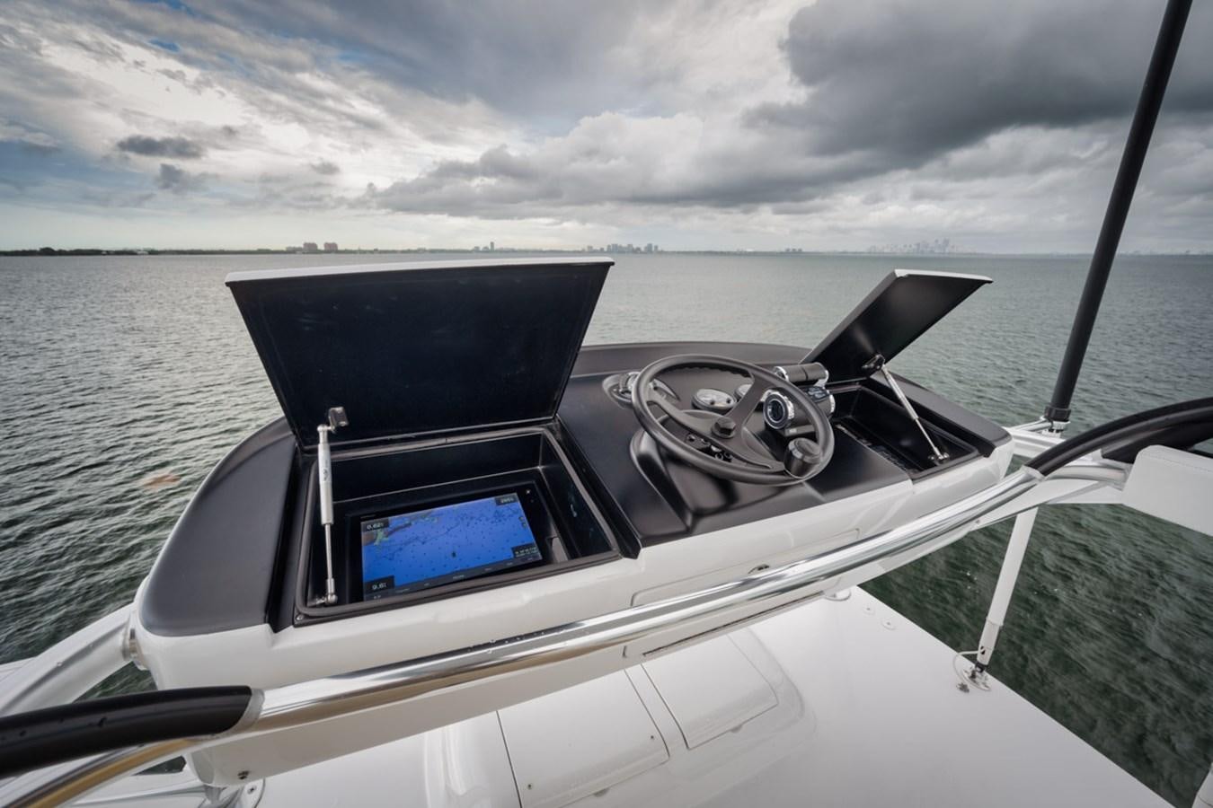 a boat with a steering wheel aboard FULL TIME Yacht for Sale