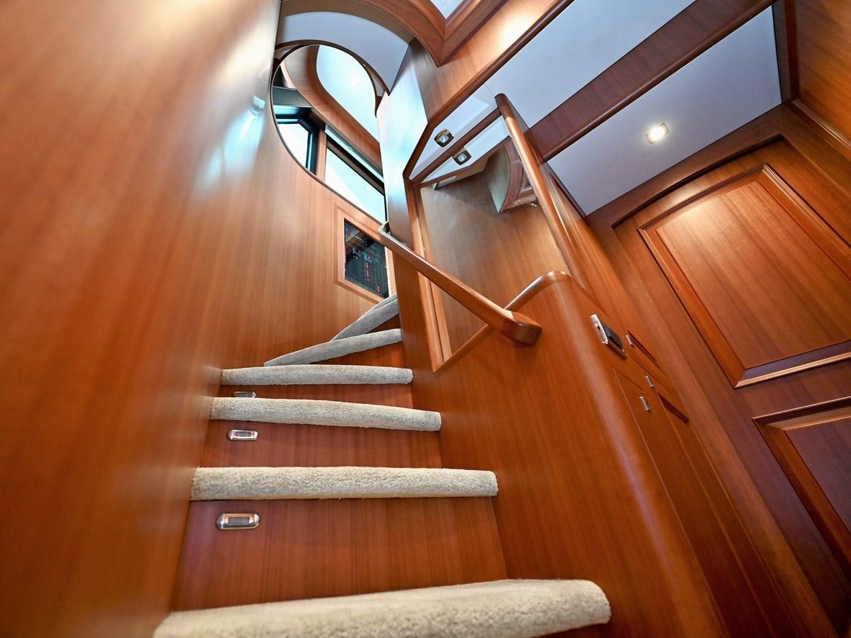 a wooden staircase with a wood railing aboard KNOT FLYING Yacht for Sale