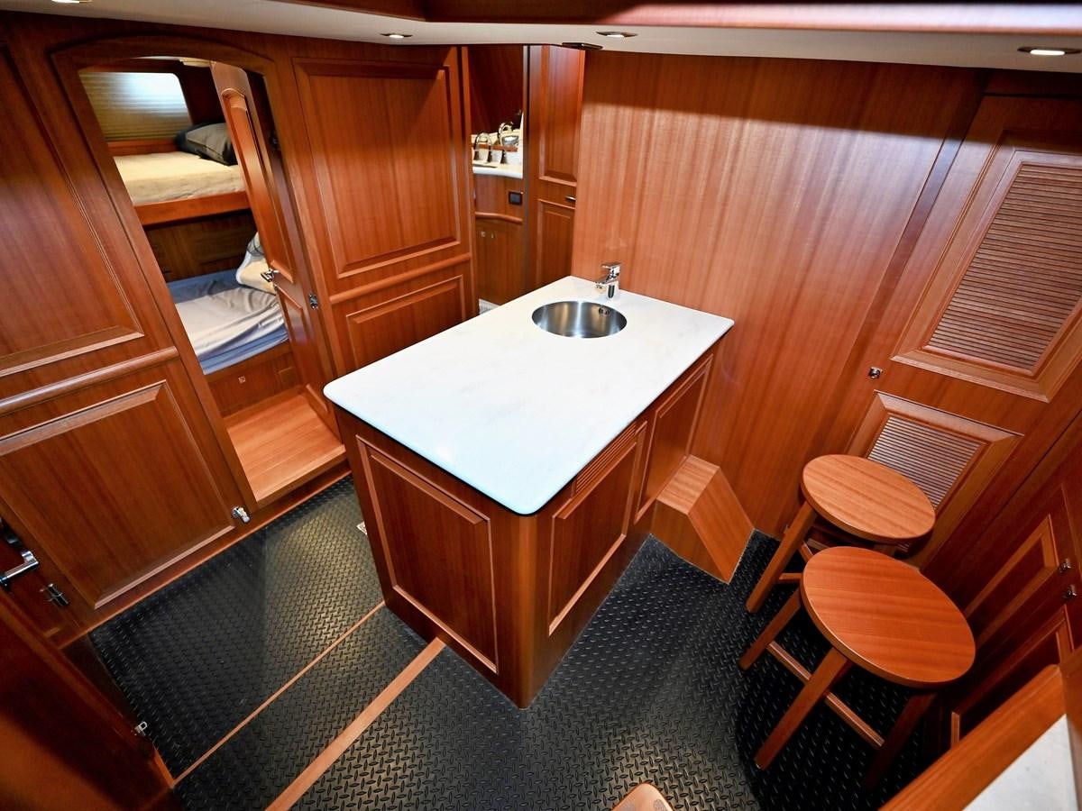 a bathroom with a sink and a table aboard KNOT FLYING Yacht for Sale