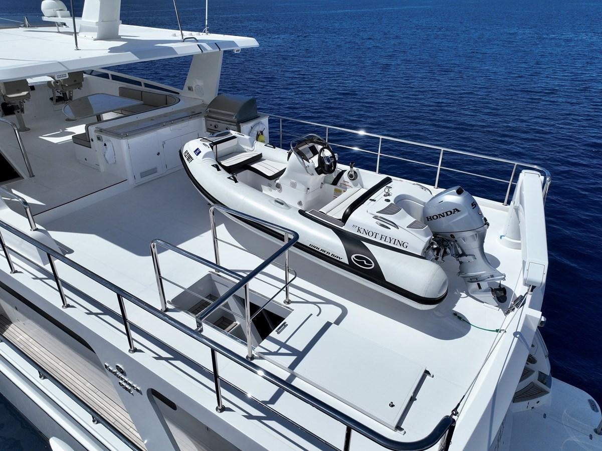 a white boat on the water aboard KNOT FLYING Yacht for Sale