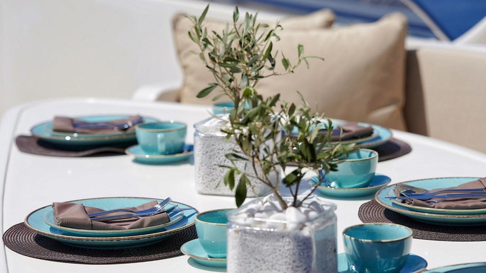 a table with plates and cups aboard SANSARA Yacht for Sale