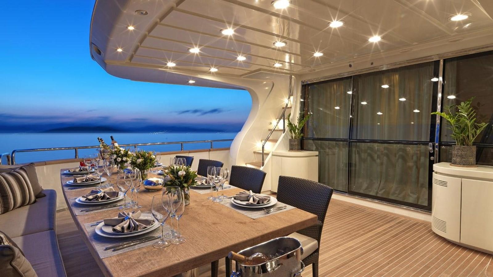 a large room with a table and chairs aboard SANSARA Yacht for Sale