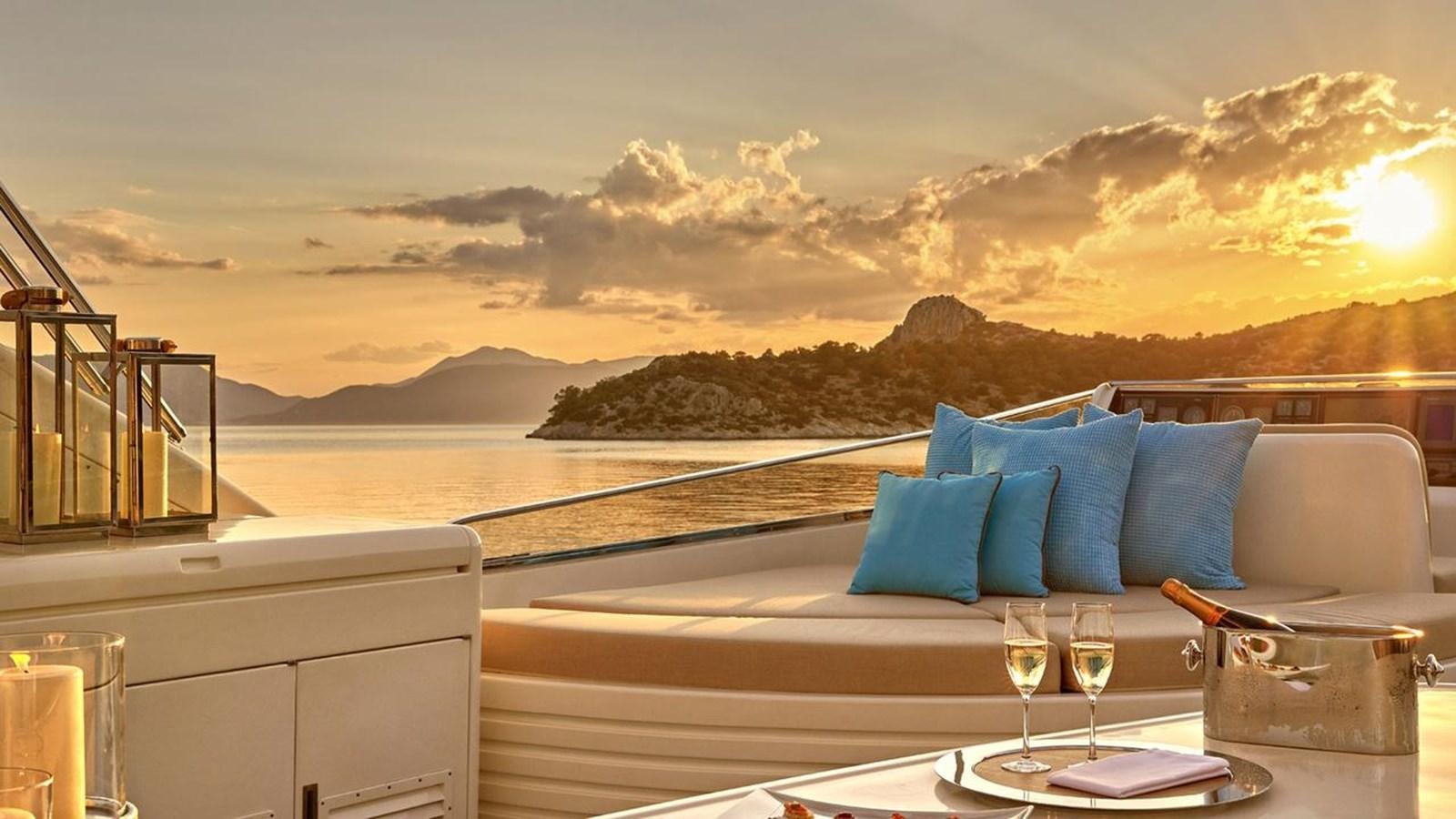 a room with a view of the ocean and a sunset aboard SANSARA Yacht for Sale
