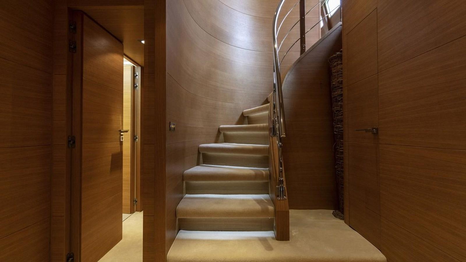a flight of stairs in a wooden room aboard SANSARA Yacht for Sale