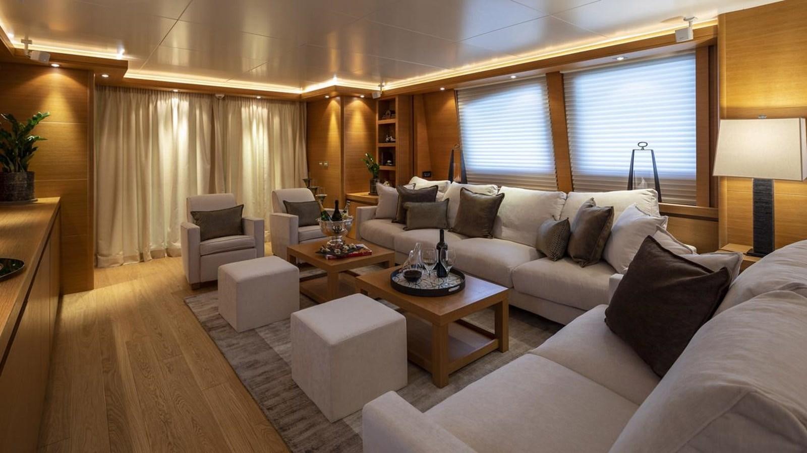 a living room with a white couch and a coffee table aboard SANSARA Yacht for Sale
