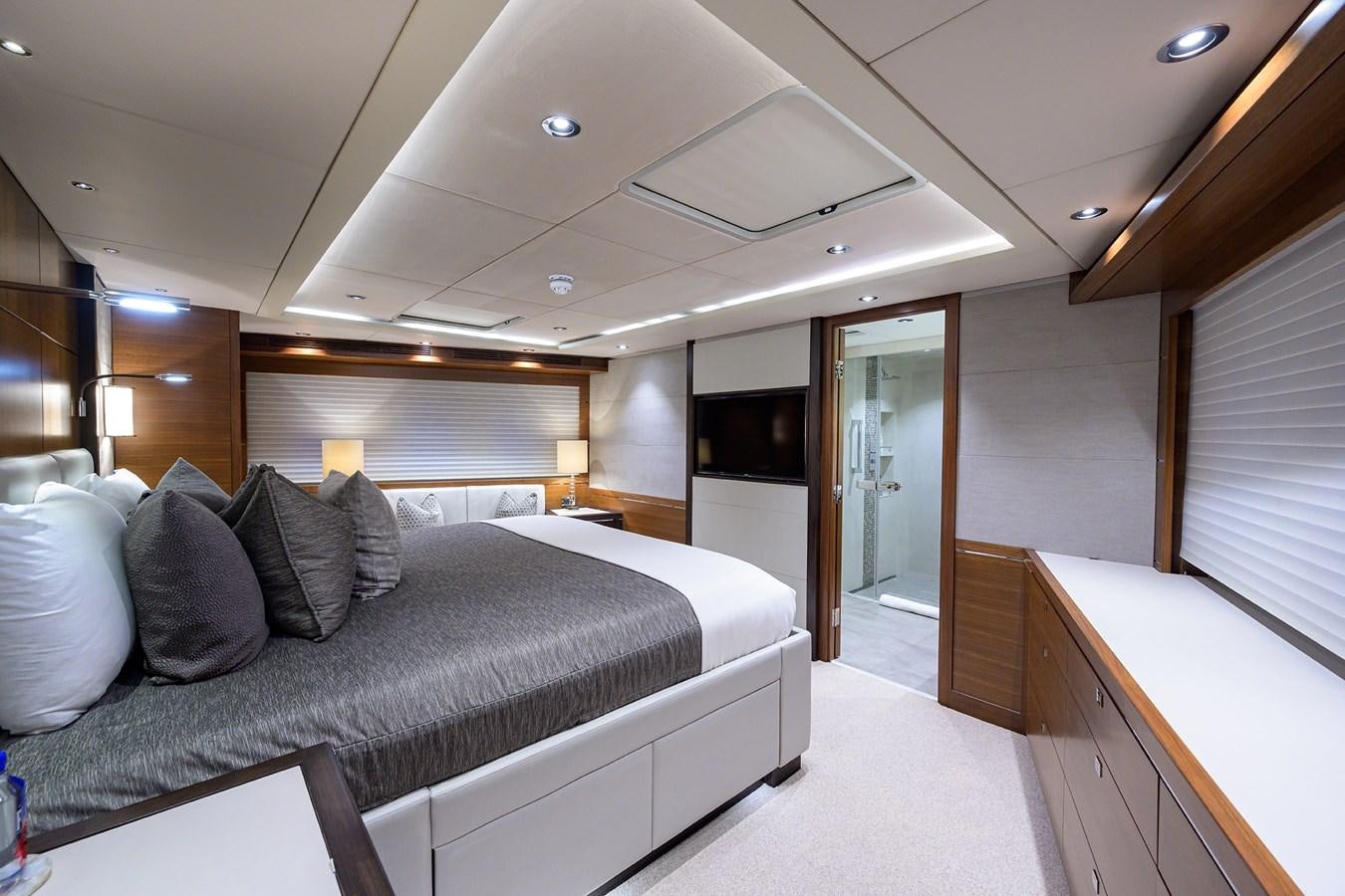 a bedroom with a bed and a large window aboard LACEY KAY Yacht for Sale