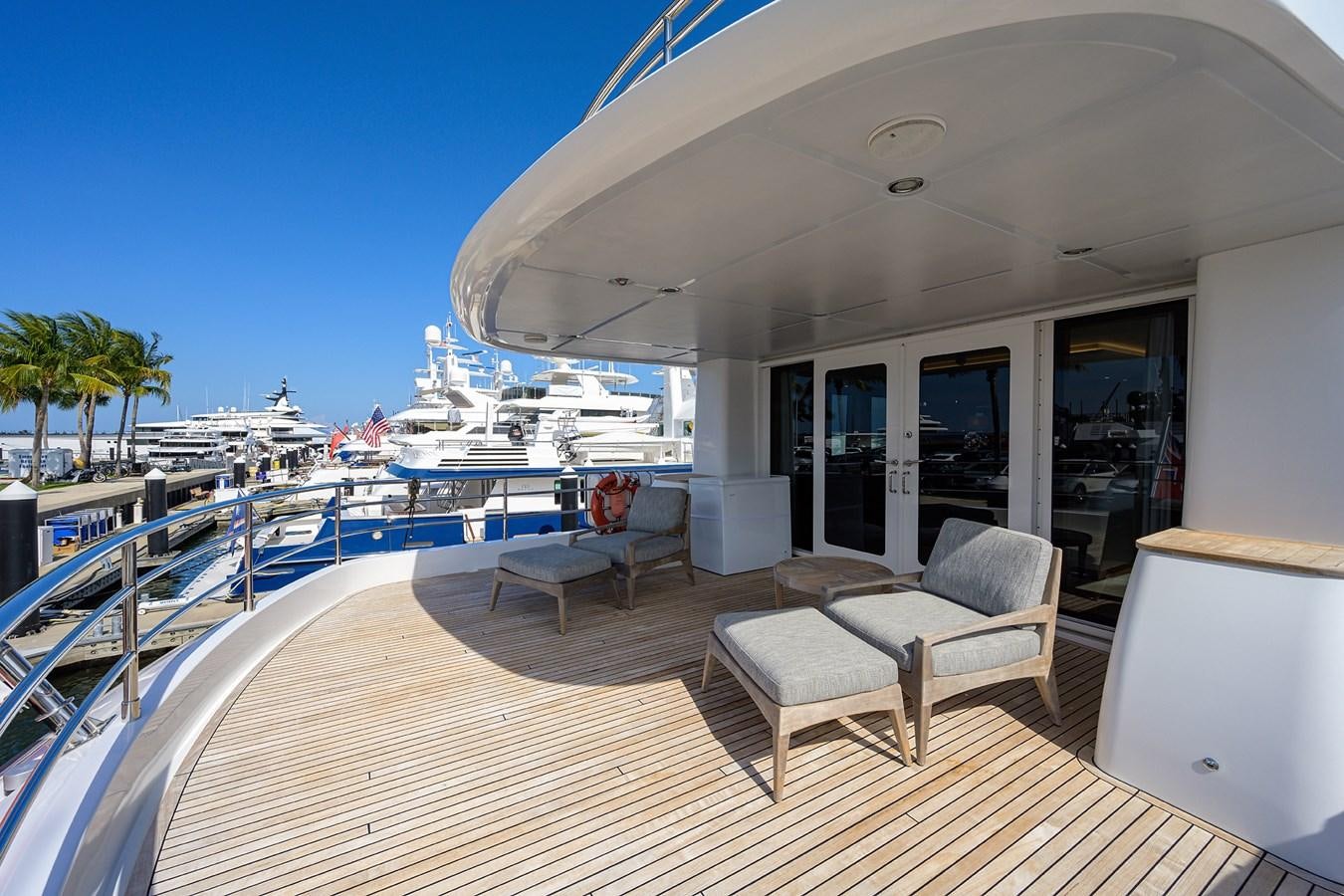 a deck with a view of the ocean and a large cruise ship aboard LACEY KAY Yacht for Sale