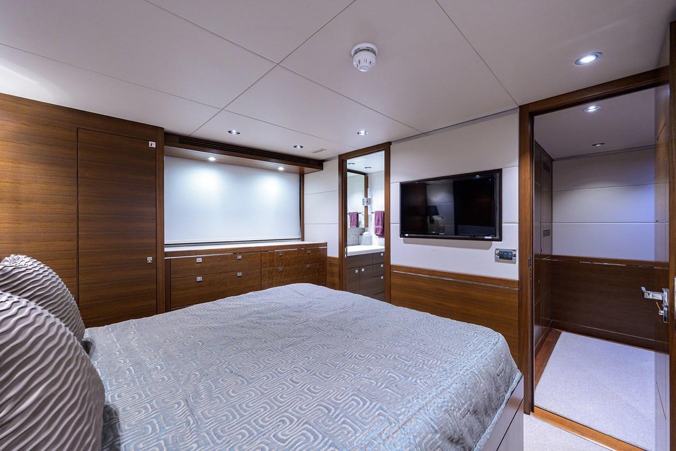 a bedroom with a bed and a television aboard LACEY KAY Yacht for Sale