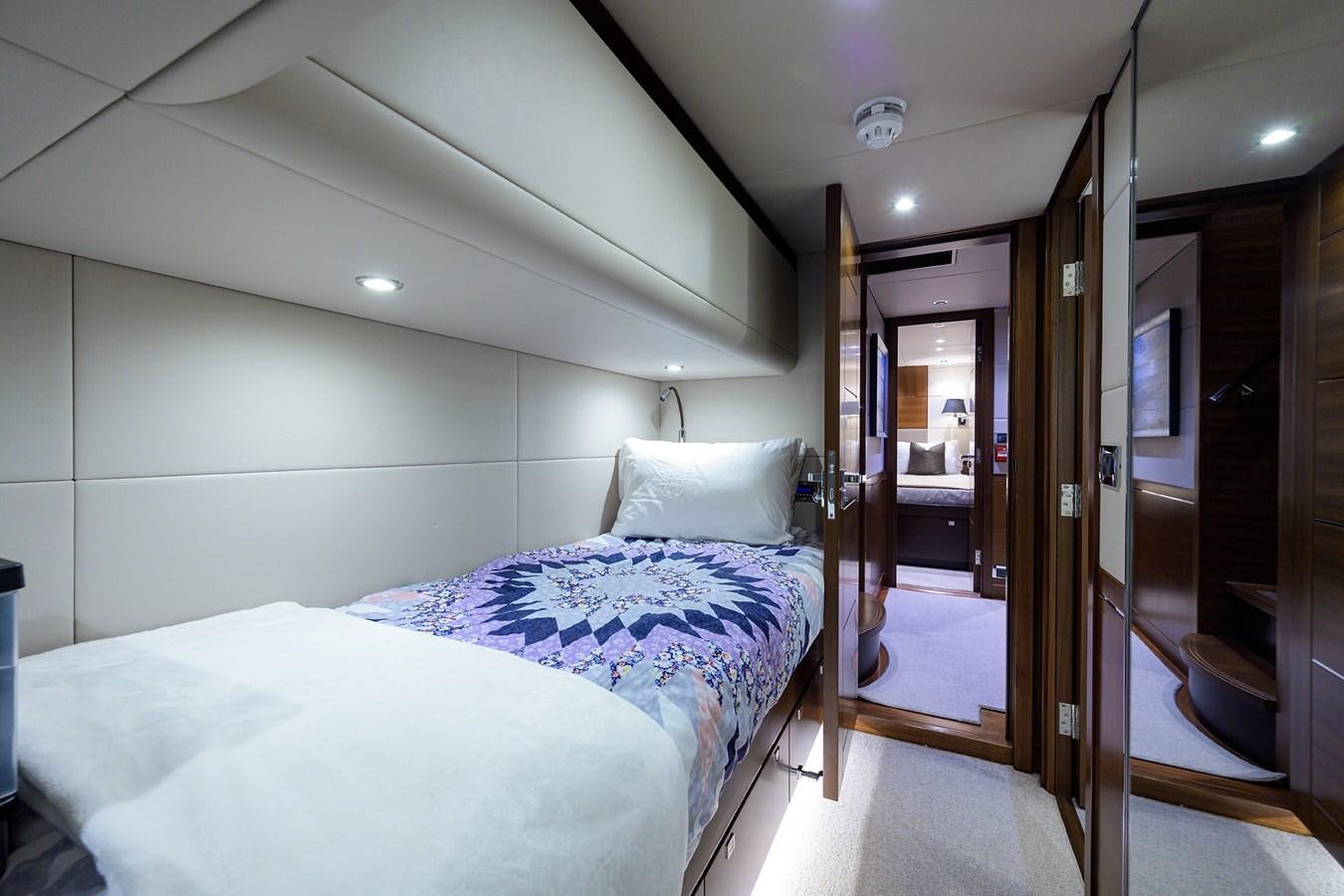 a bedroom with a bed and a mirror aboard LACEY KAY Yacht for Sale