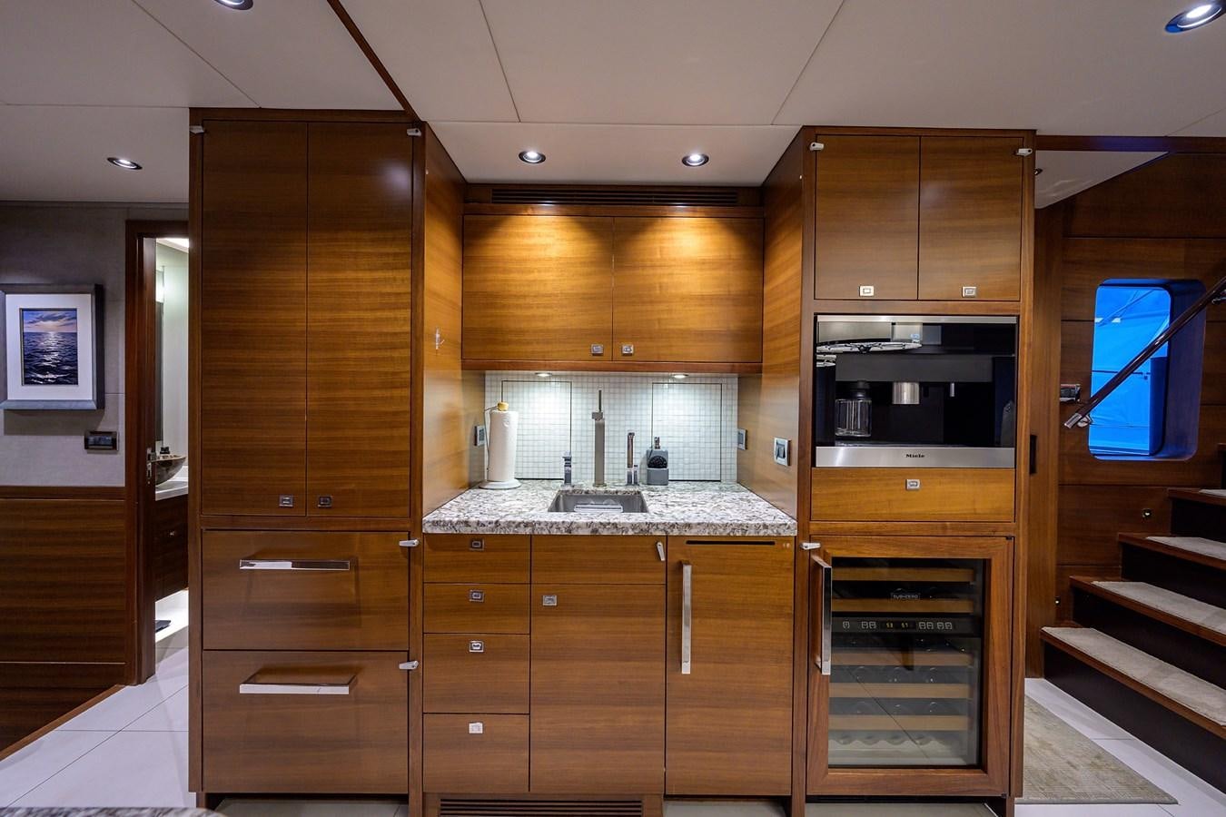 a kitchen with wooden cabinets aboard LACEY KAY Yacht for Sale