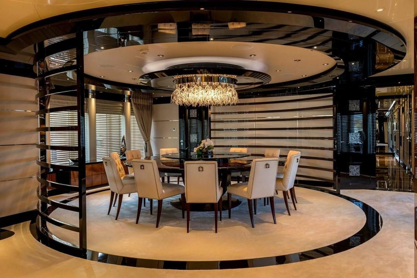 a room with a table chairs and a chandelier aboard TALISMAN C Yacht for Sale