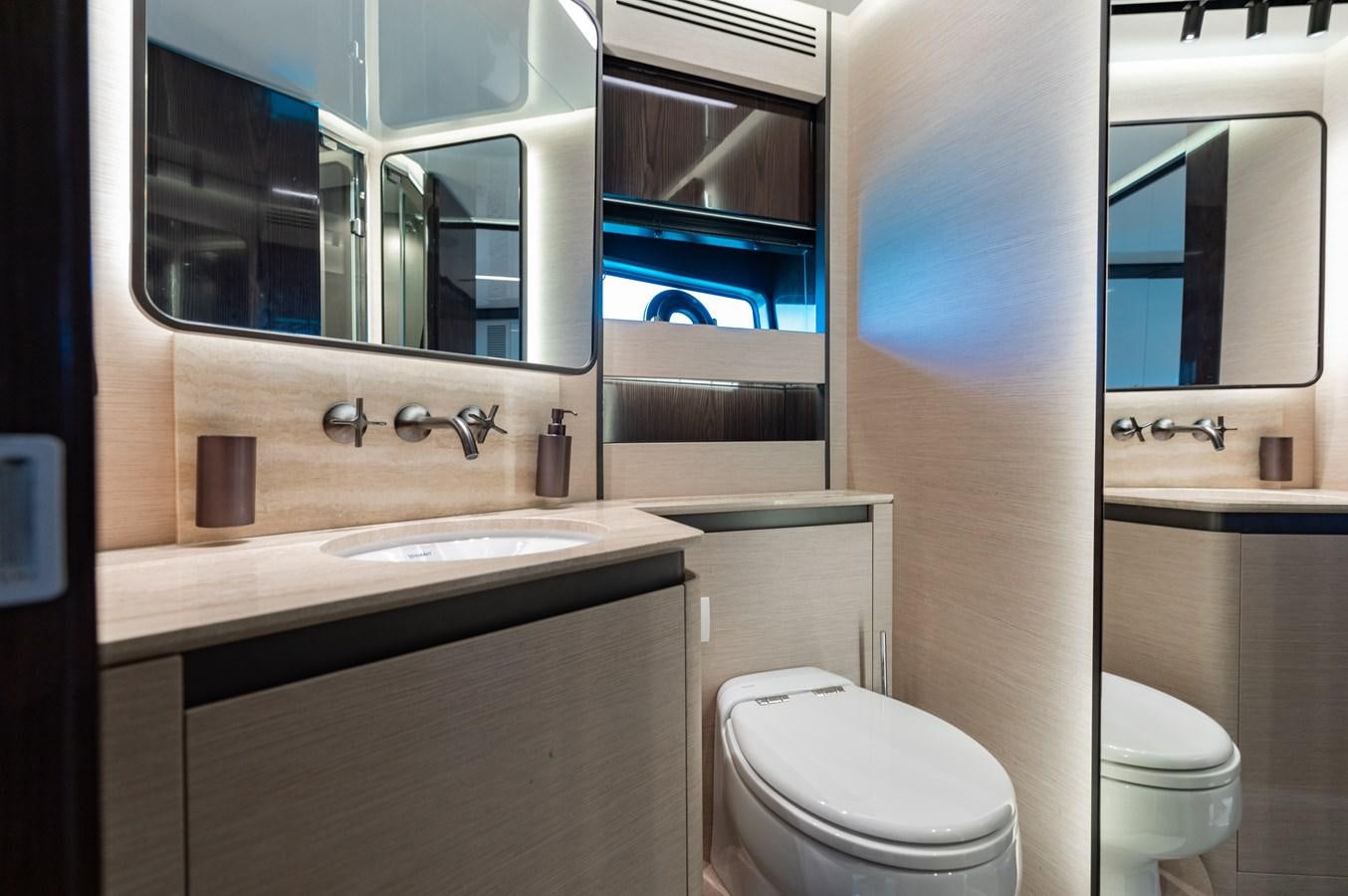 a bathroom with a sink toilet and a mirror aboard BASH II Yacht for Sale