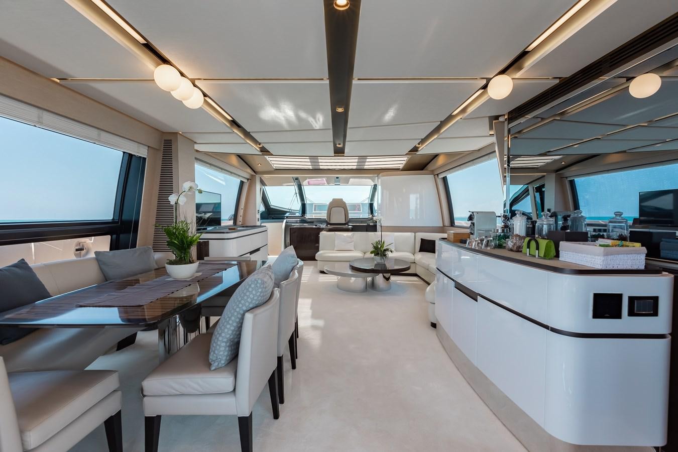 a room with a table chairs and a large window aboard BASH II Yacht for Sale