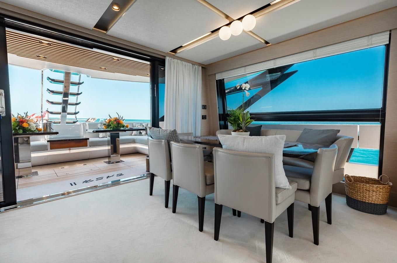 a room with a table and chairs aboard BASH II Yacht for Sale