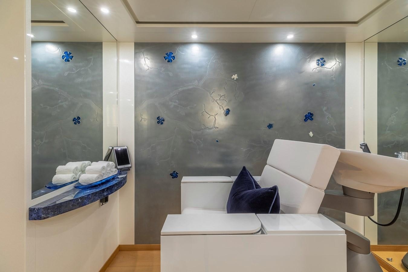 a room with a white bed and a blue pillow aboard FELIX Yacht for Sale