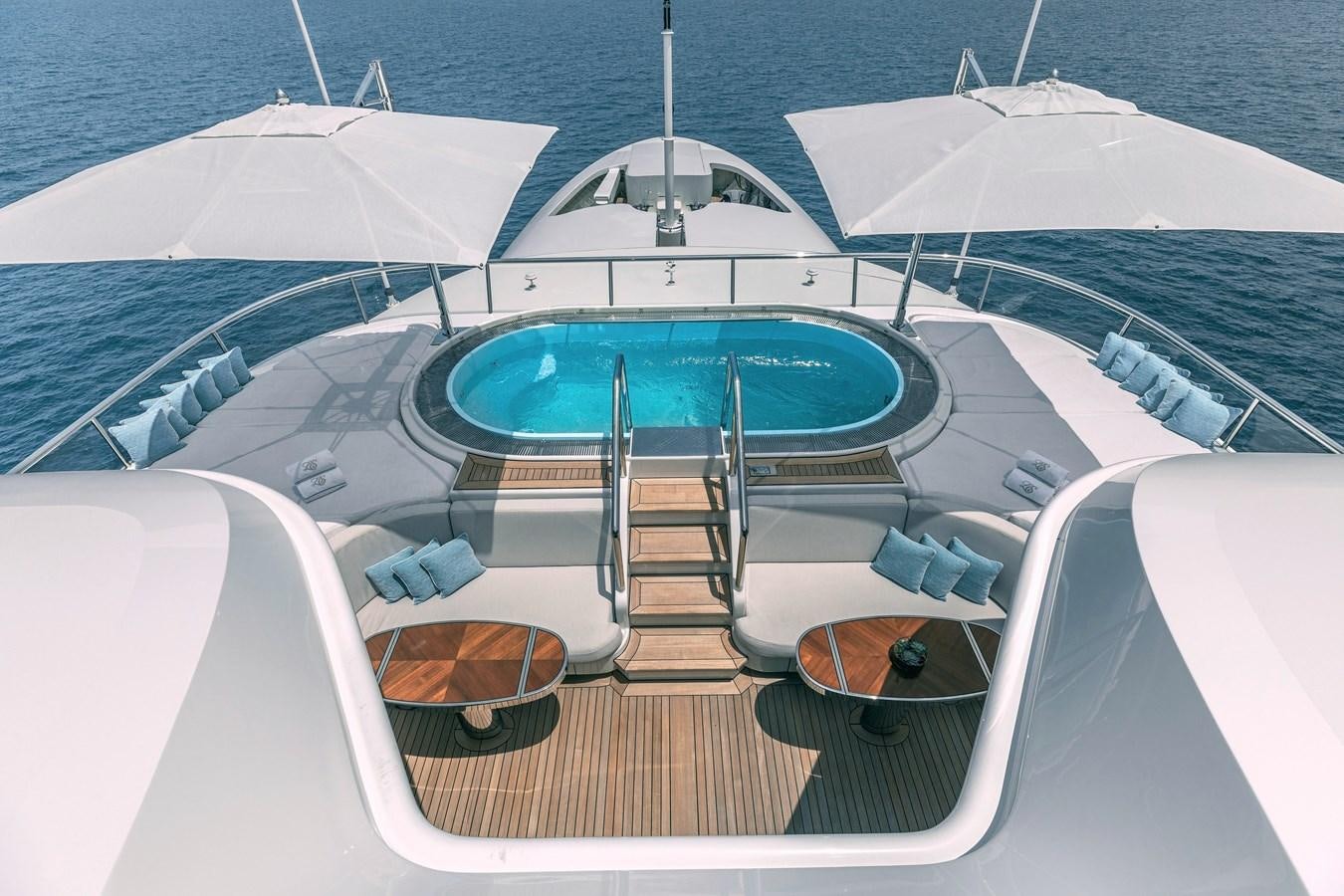 a boat with a blue umbrella aboard FELIX Yacht for Sale