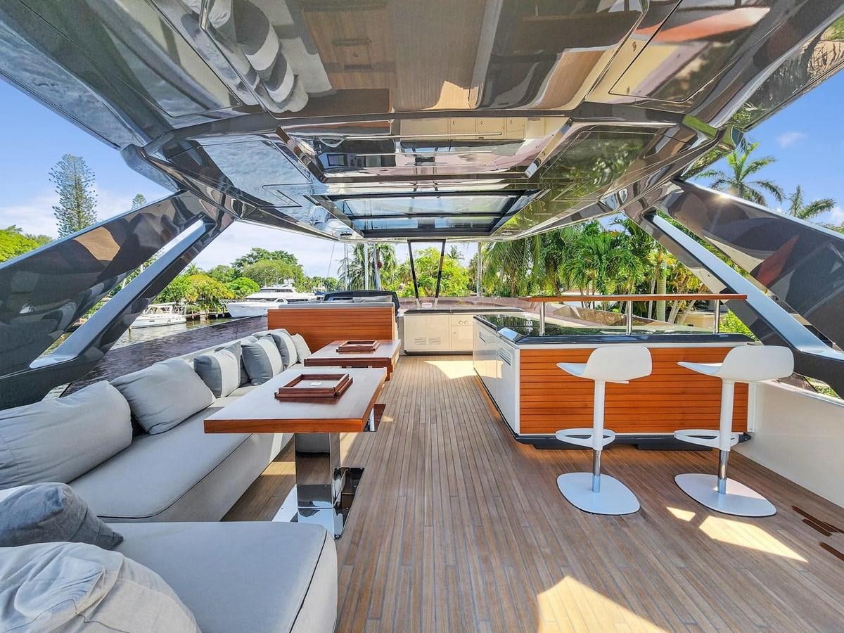 a room with a wood floor and a table with chairs and a large white umbrella aboard XFAF8532J021 Yacht for Sale