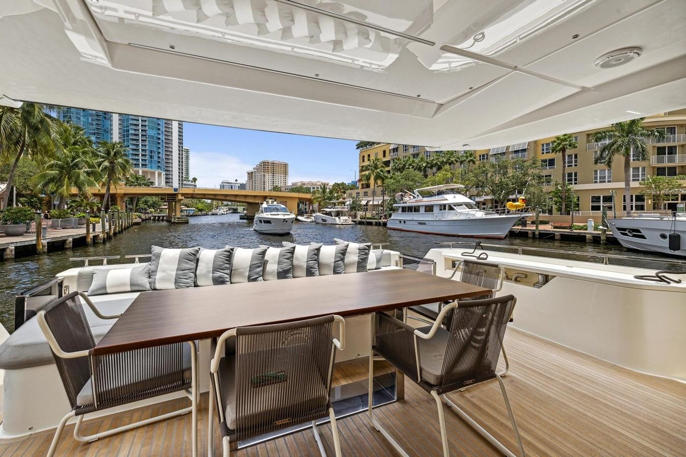 a table and chairs on a deck aboard XFAF8532J021 Yacht for Sale